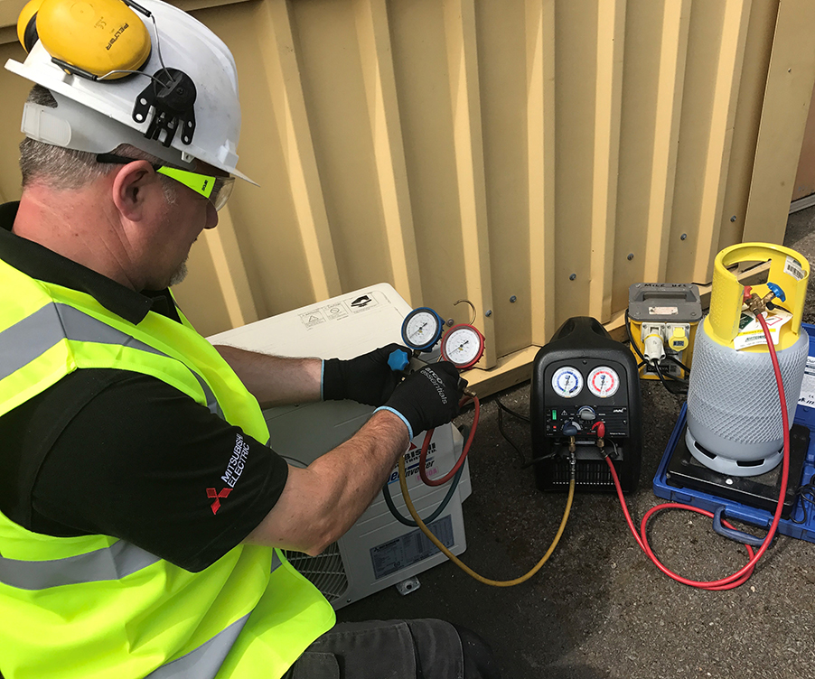 Technician recovering refrigerant.